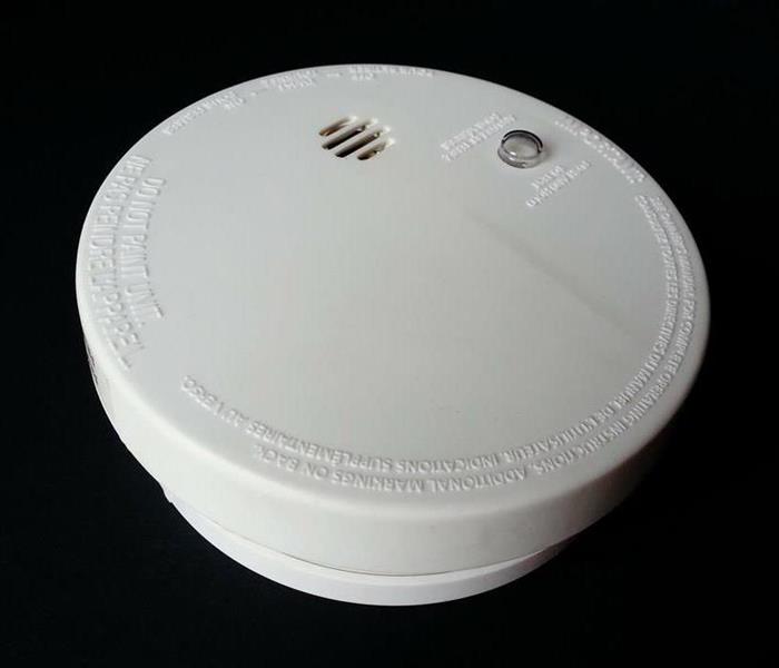 A smoke detector on a ceiling