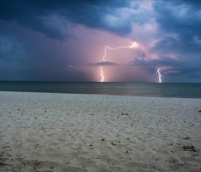 Lightning flashes above a beach