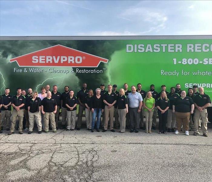 SERVPRO workers stand in front of a SERVPRO truck