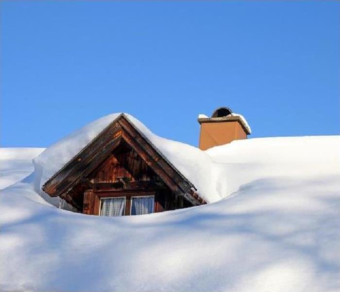 Snow is piled high on a rooftop