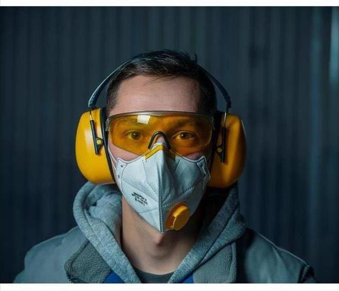 Man wearing respirator mask and goggles