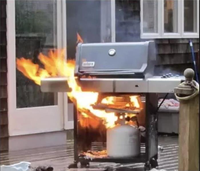 A gas grill is on fire