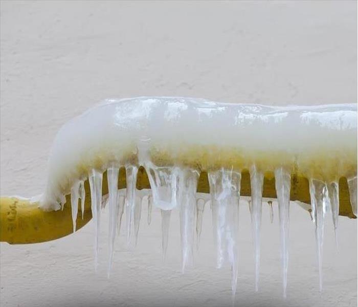 Ice hangs off a frozen pipe